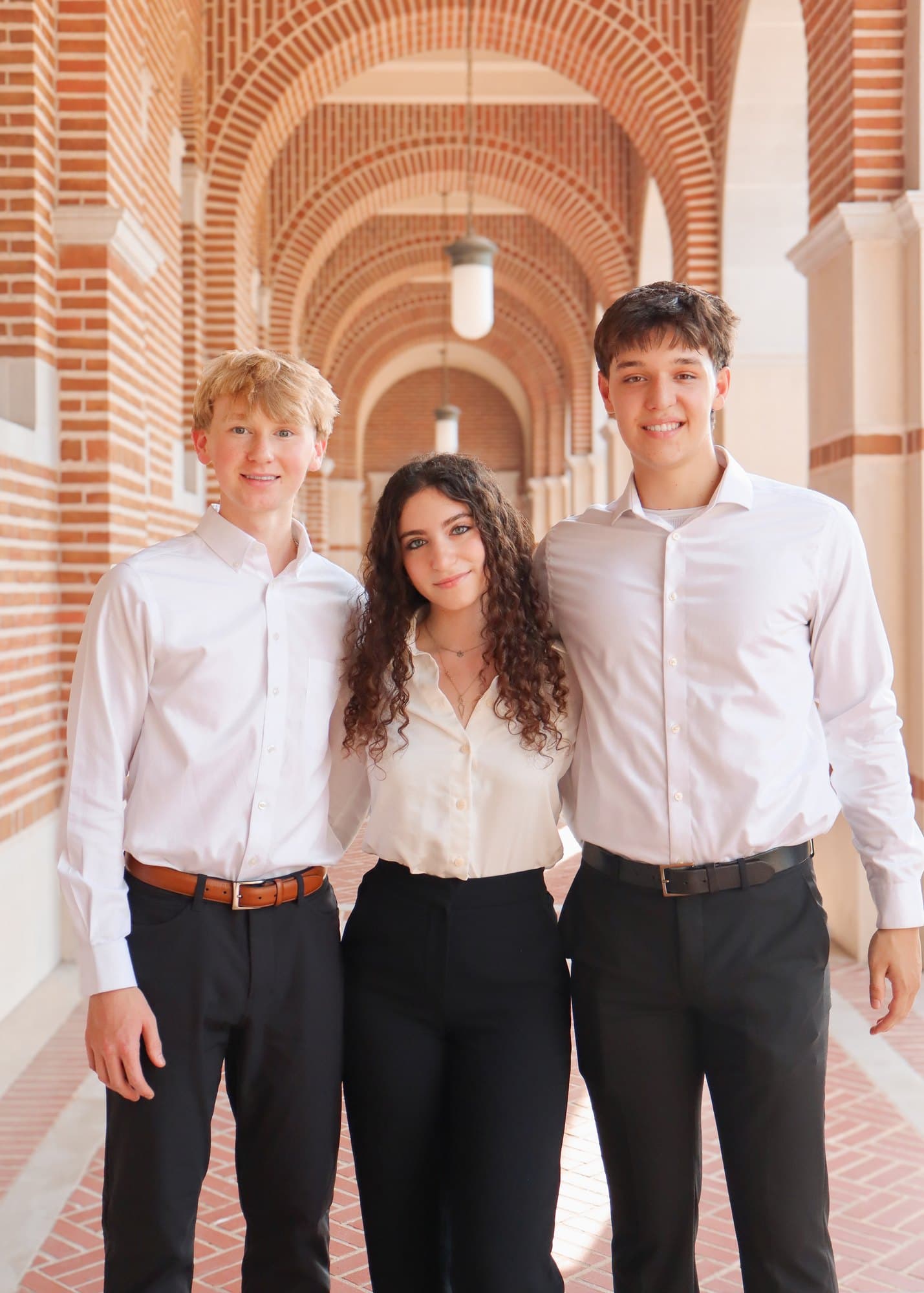Three Rice Business Society members in the Rice University loggia